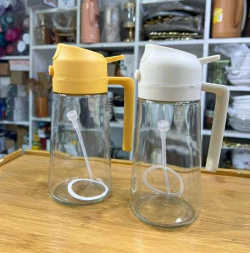 2-in-1 glass oil dispenser and spray bottle with a beige lid